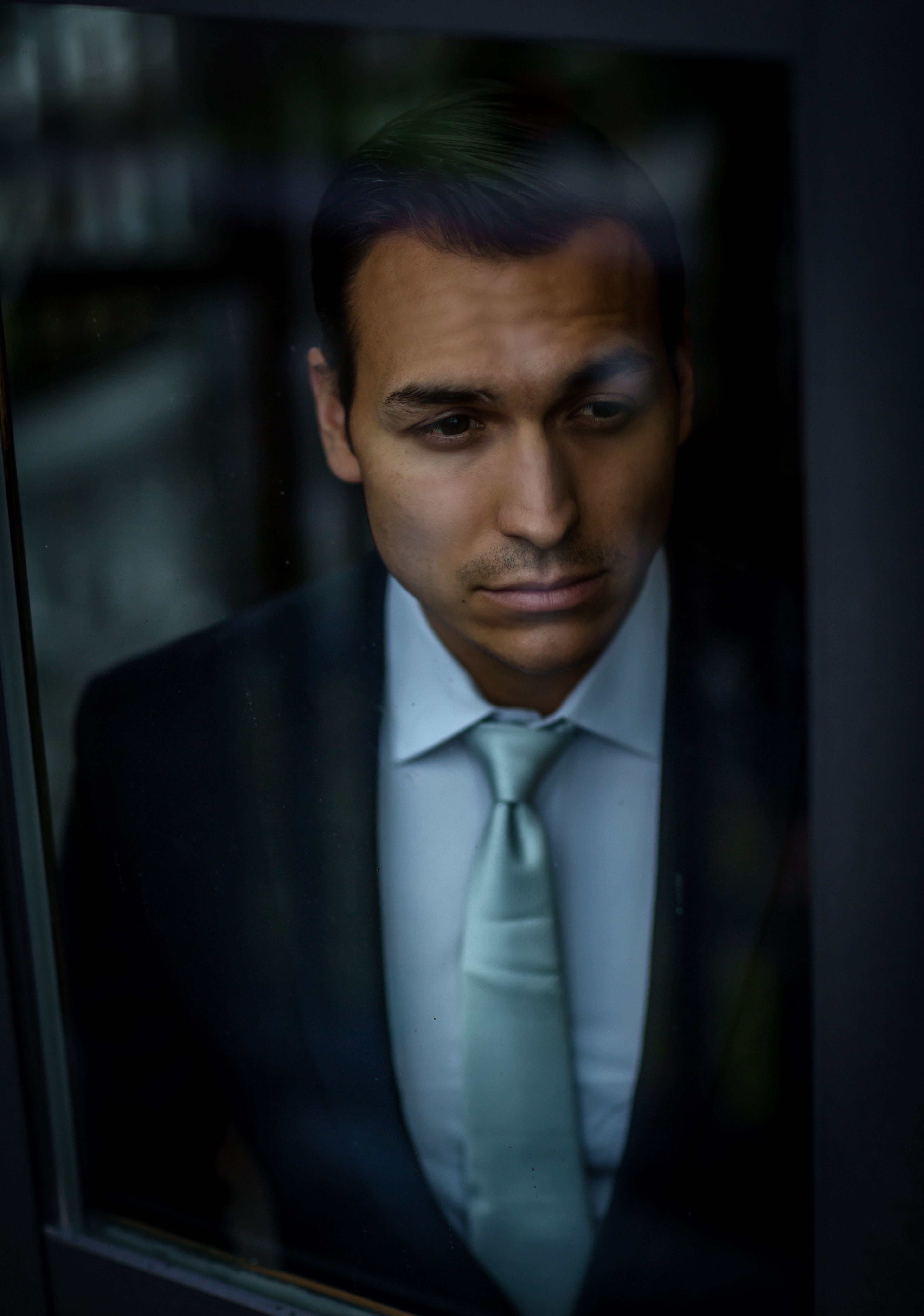 Man in Black Suit Looking out the Window · Free Stock Photo