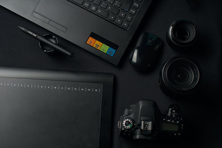 Modern Black Photography Equipment And Computer On Table