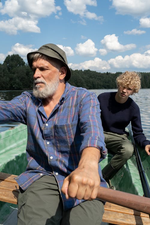 Free Grandfather and Grandson on Boat Ride on Lake in Summer Stock Photo