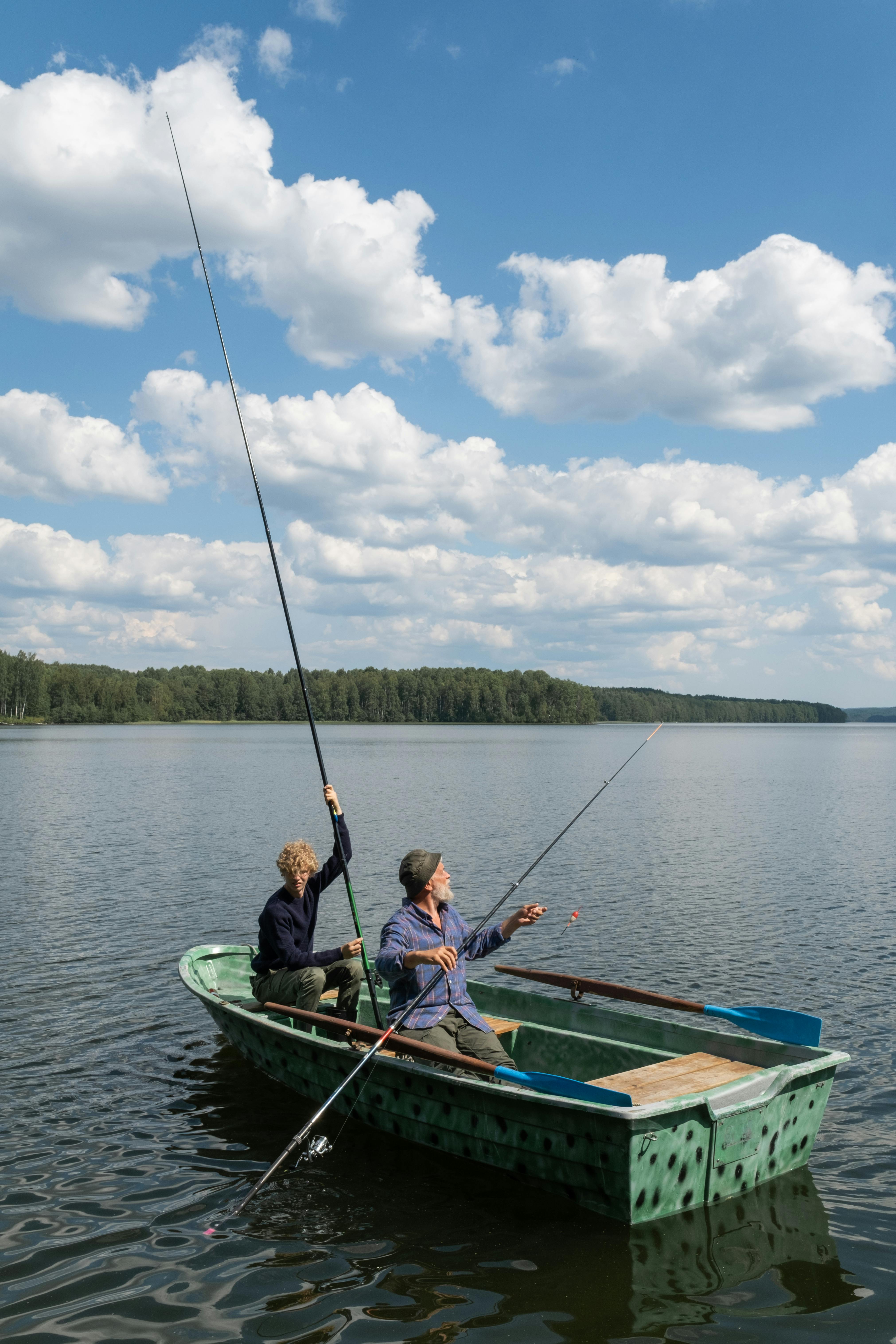 A serene scene of a grandfather and grandson fishing together in a boat on a lake under a blue sky.