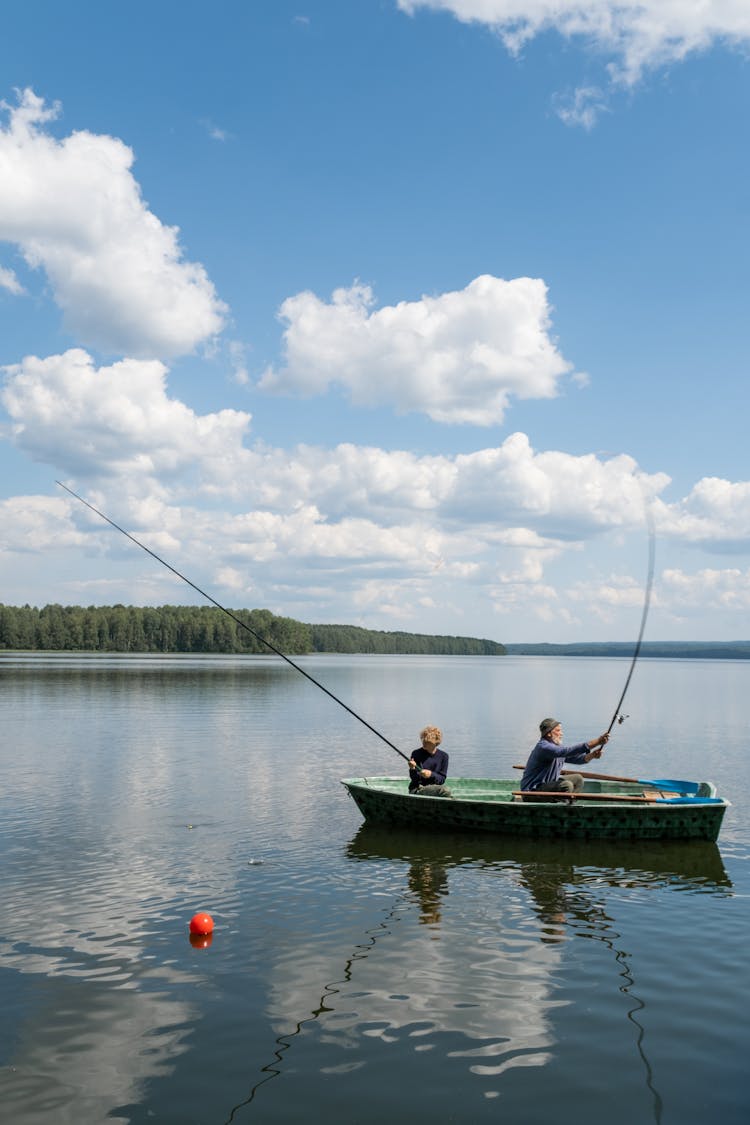 People In A Boat Fishing In A Lake