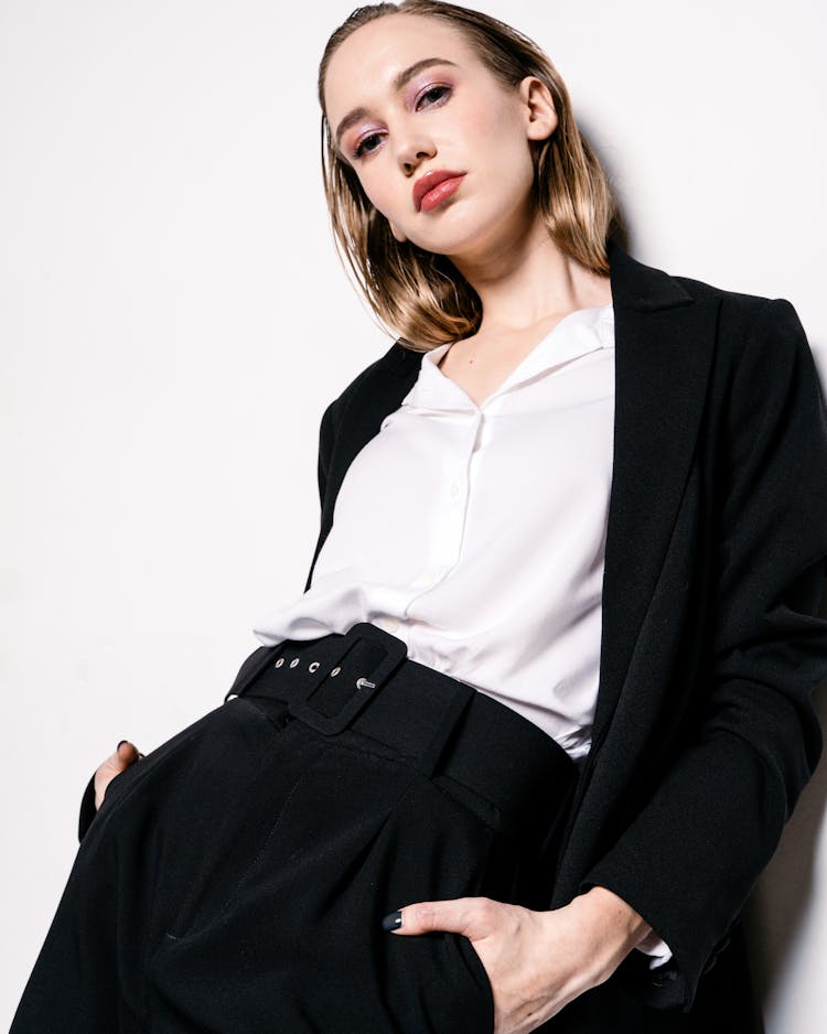 A Low Angle Shot Of A Woman In Black Blazer Leaning On The Wall