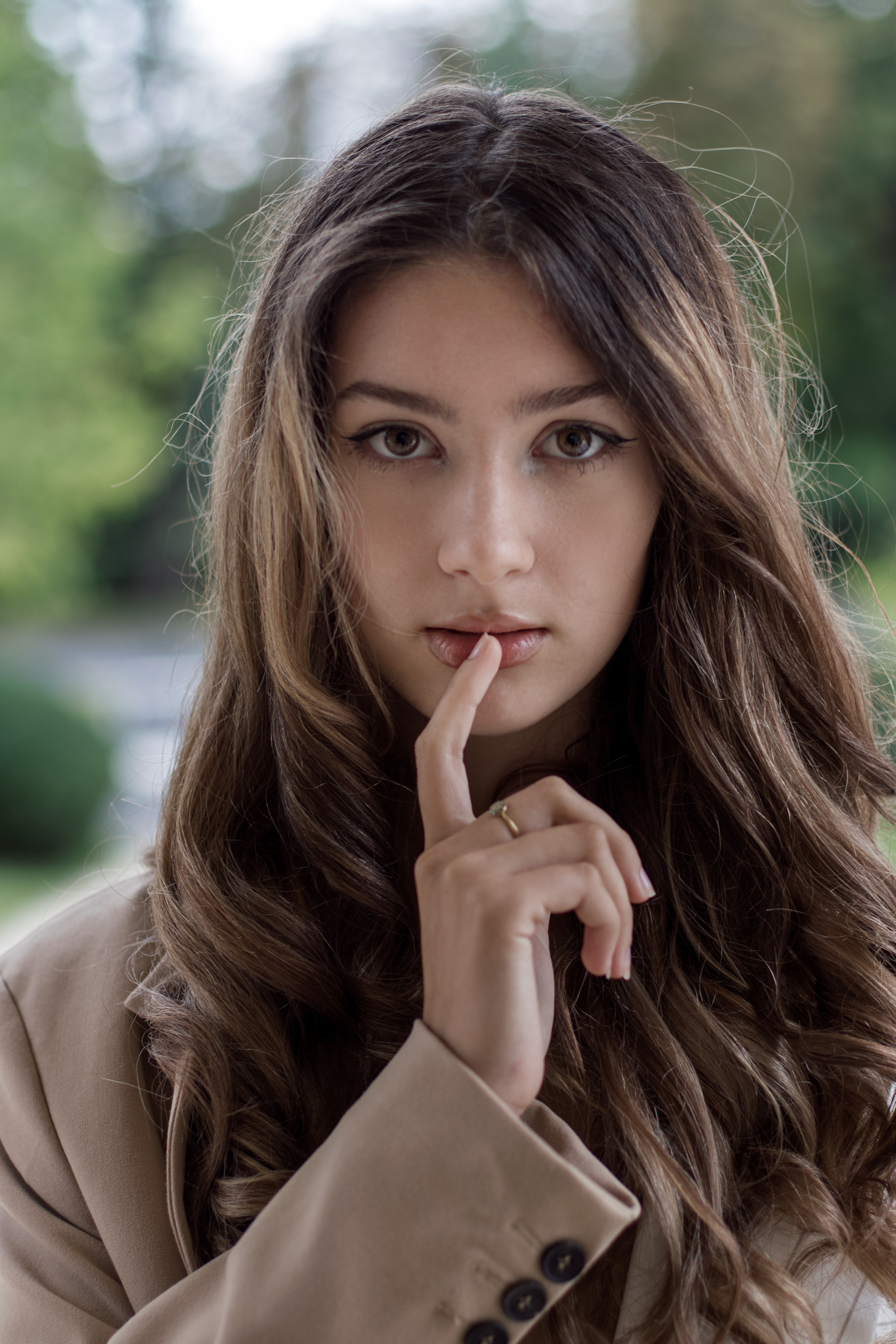 Close-up portrait of a young woman in a park with a thoughtful expression, Brașov, Romania.