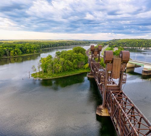 Free A stunning aerial photograph of a rusty railroad bridge crossing the Mississippi River in Prescott, Wisconsin. Stock Photo