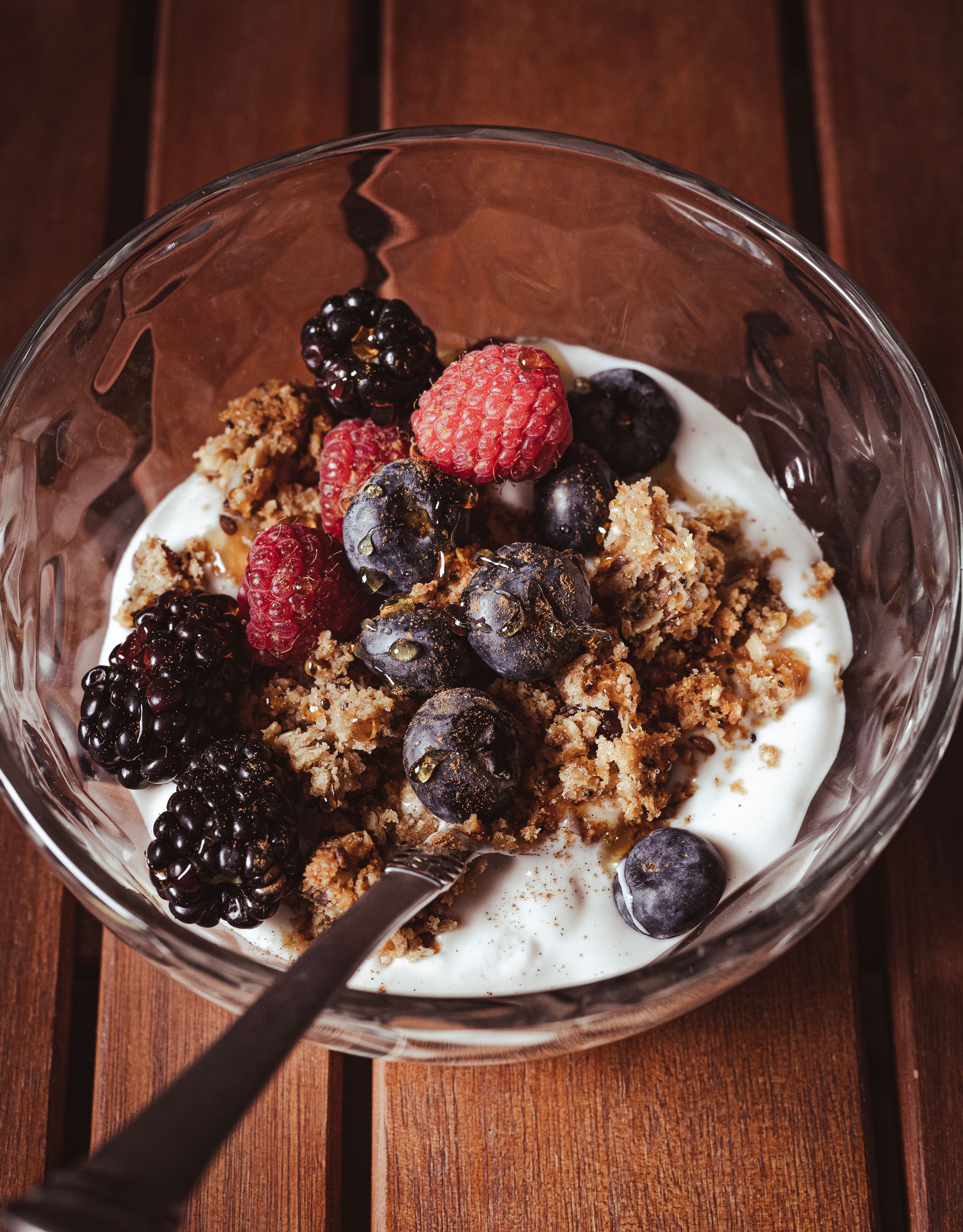 Bowl of yogurt with berries, granola, and nuts