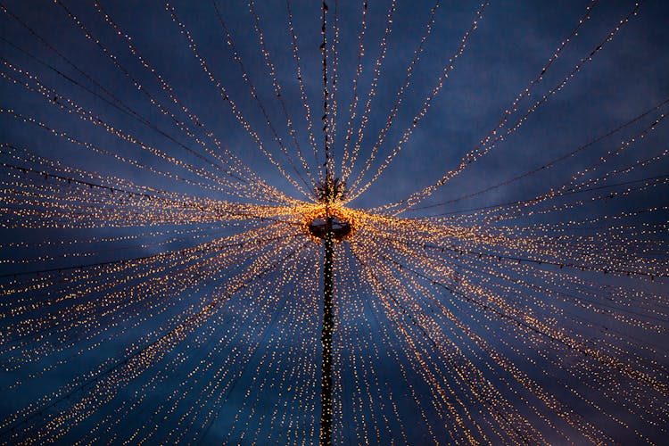 Strings Of Lights Coming Off From A Pole