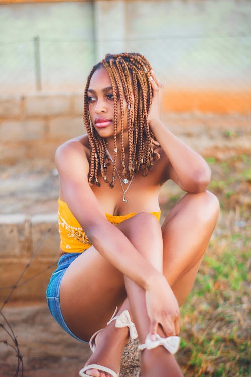 Woman in Yellow Tube Top and with Braided Hair