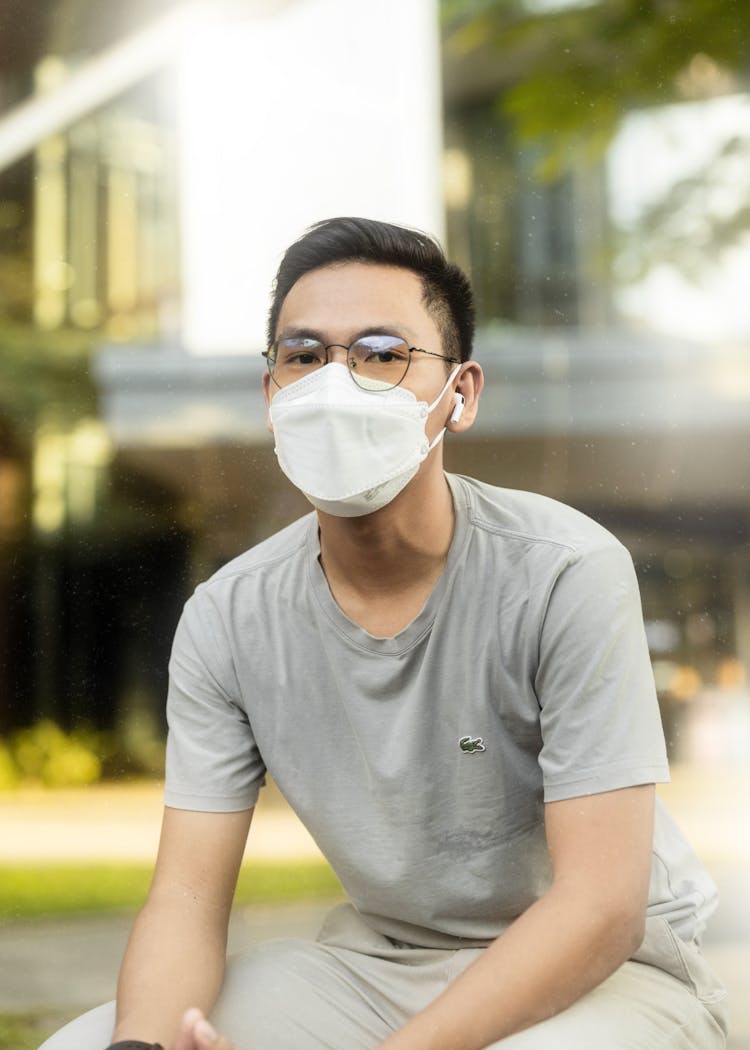 Man In Gray Crew Neck T-shirt Wearing A White Face Mask