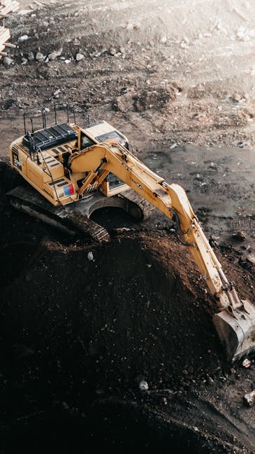 Aerial view of an excavator working at a construction site in İstanbul. Aerial view of an excavator working at a construction site in İstanbul.