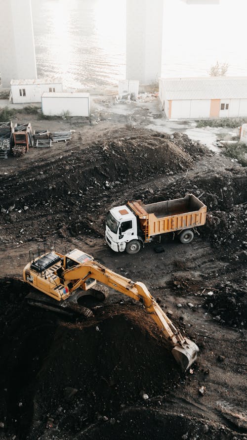 Free A Truck and an Excavator on a Construction Site Stock Photo