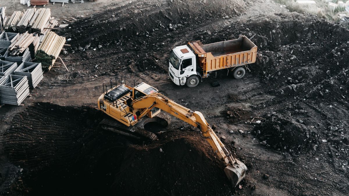 Excavator loading a dump truck at a construction site