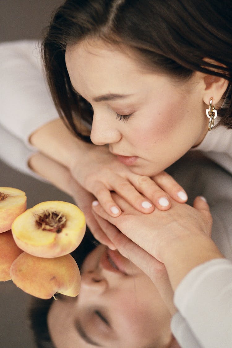 Woman With Closed Eyes Relaxing With Peach Scent