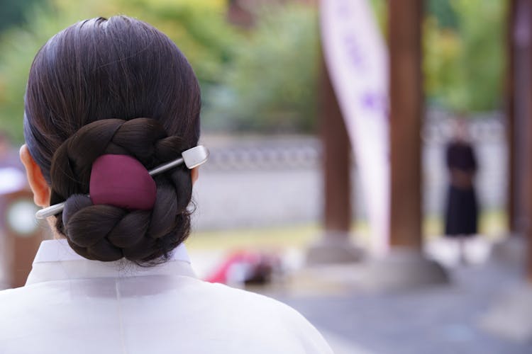 Braided Bun In Brown Hair Of A Woman