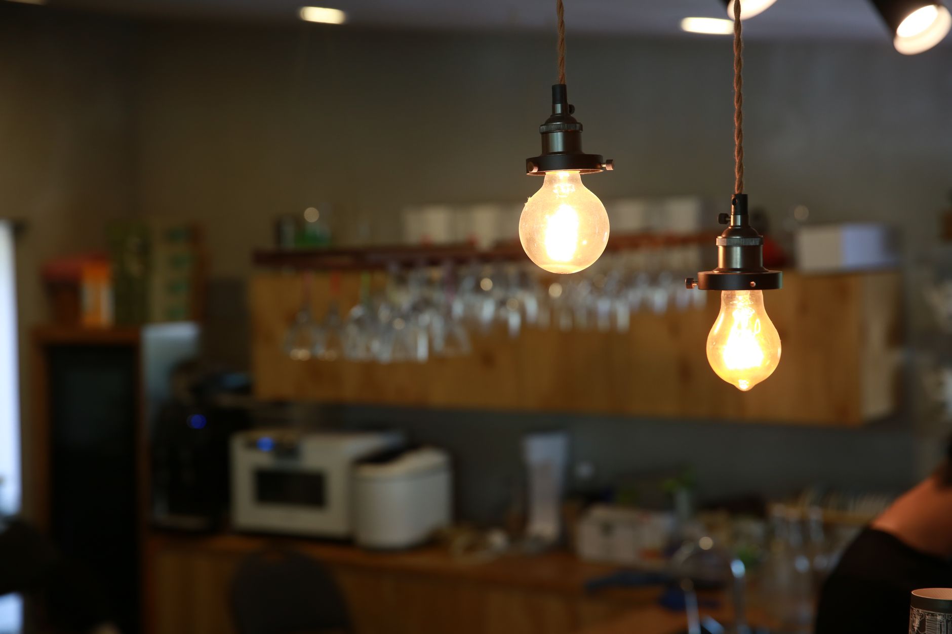 Close-up of glowing light bulbs hanging in a cozy indoor setting with warm ambiance.