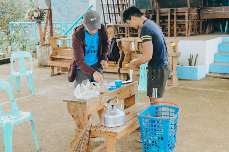 Men Making Breakfast On A Bench