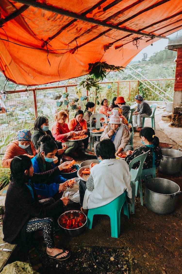 Group Of Women Peeling Carrots