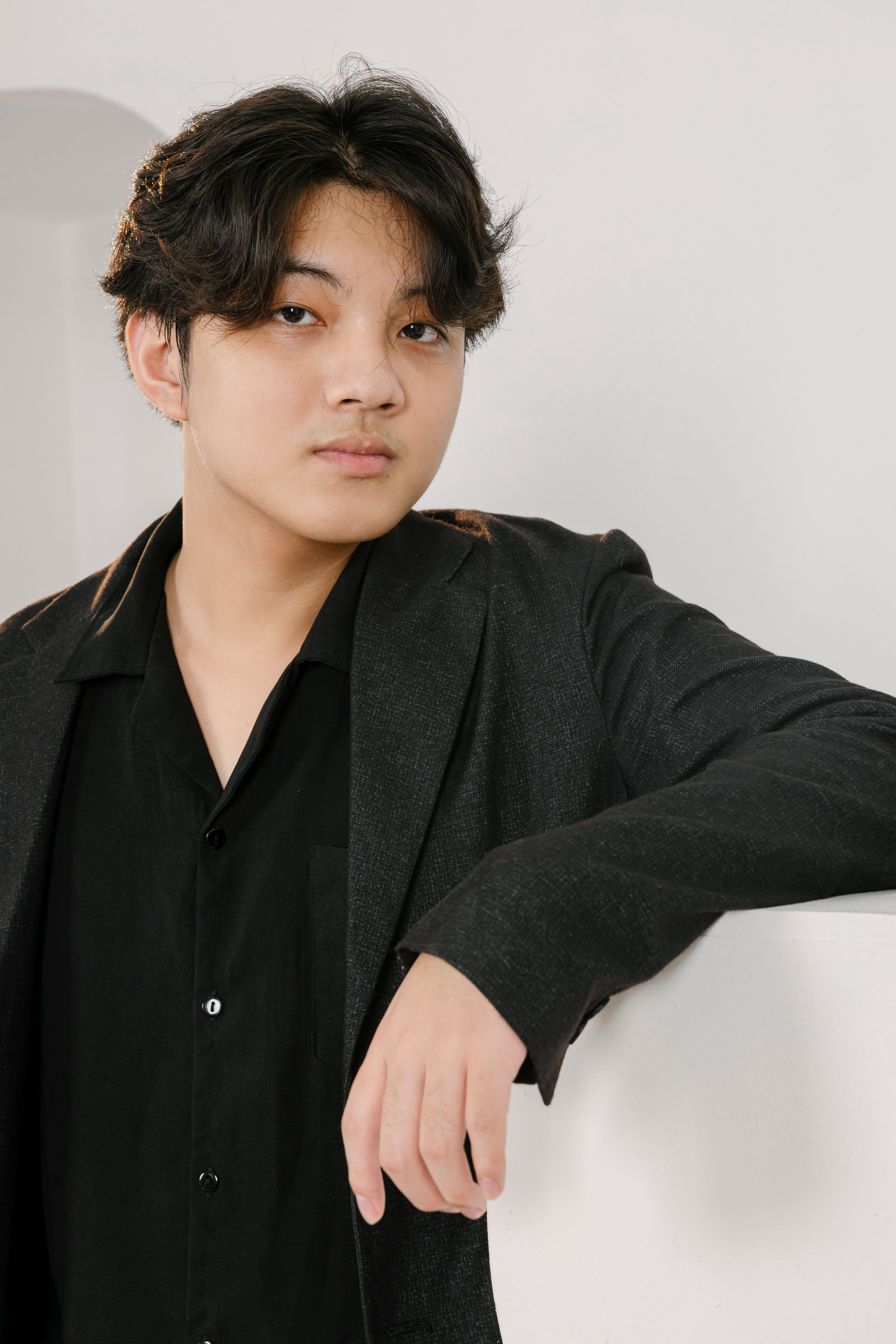 Portrait of a stylish young man posing confidently indoors.