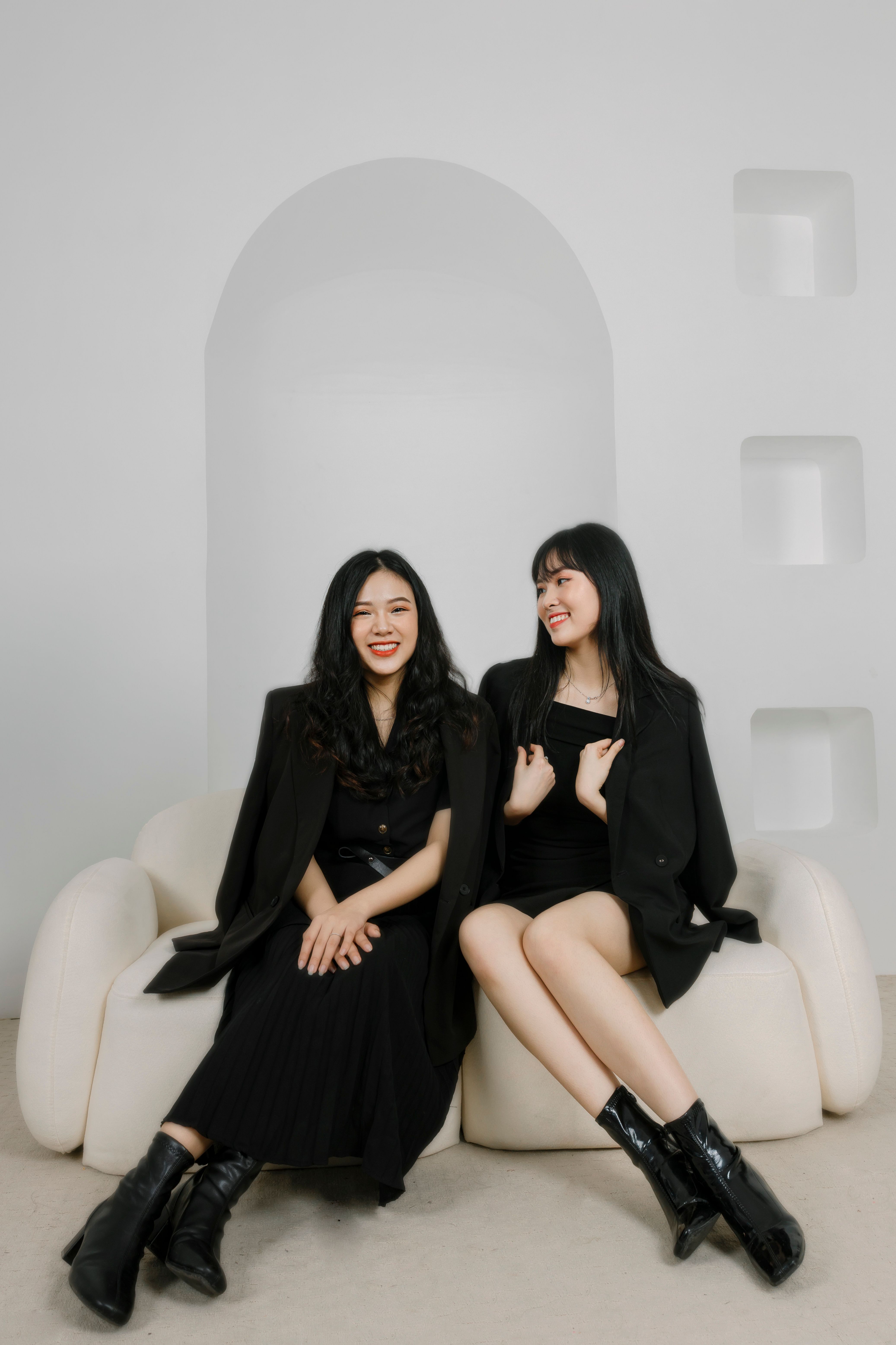 Women in Black Dresses Sitting on a Couch · Free Stock Photo