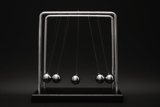Newton's cradle for physics principles and motion study on a dark background.