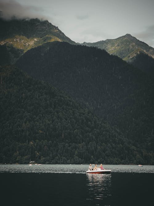 Pedal Boat Sailing on Lake in Mountains