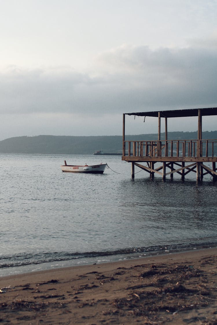 Boat Tied To A Pier On The Lake