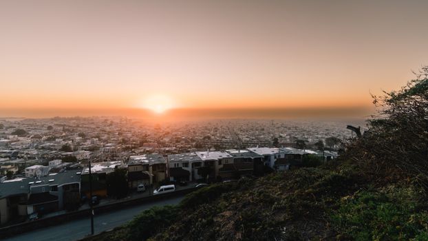 Breathtaking aerial view of San Francisco at sunset, showcasing the city's architecture and warm hues.