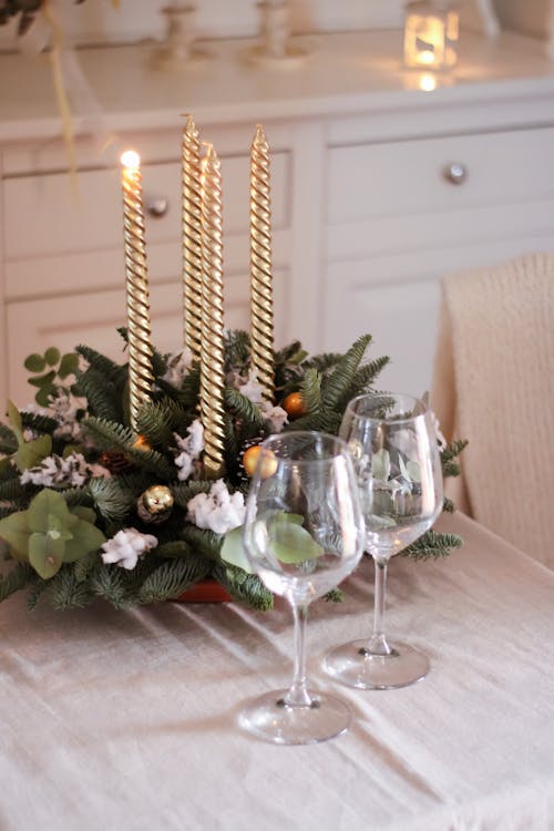 Free Candles by Wine Glasses and Christmas Decorarion Stock Photo
