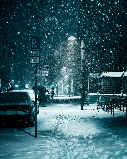 Heavy snowfall on a quiet street at night, photo by Marcel Kohler on Pexels