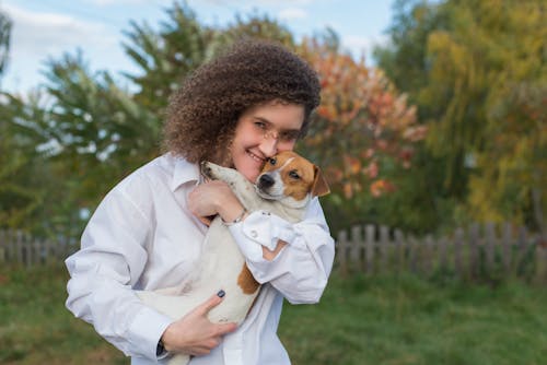 Free Happy Woman carrying her Dog  Stock Photo