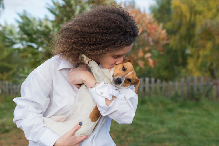 Woman Kissing A Dog