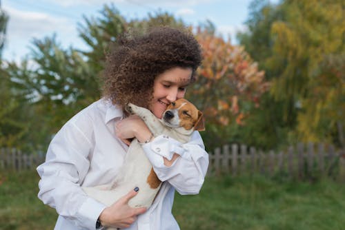 Woman Petting a Small Dog