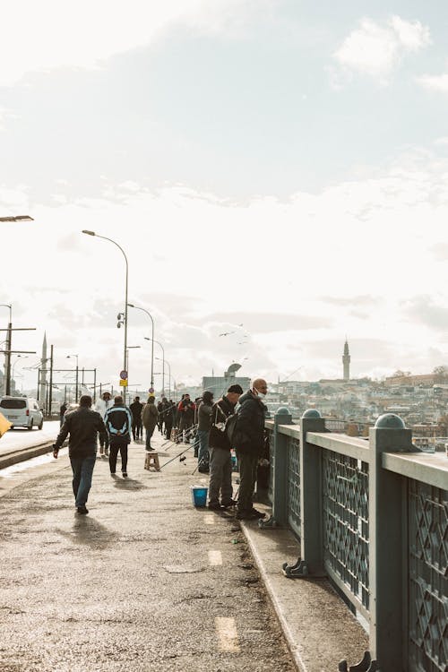 People Walking on the Street Near the Bridge