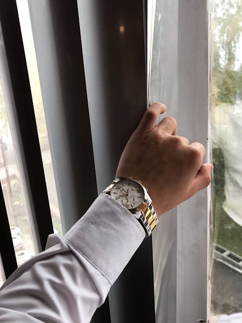 A Person in White Long Sleeves Wearing Wristwatch