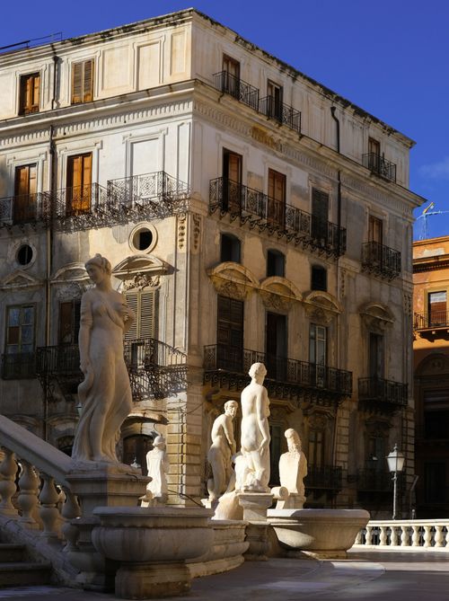 Free Statues of Fontana Pretoria with historic architecture in Palermo, Sicily, Italy. Stock Photo