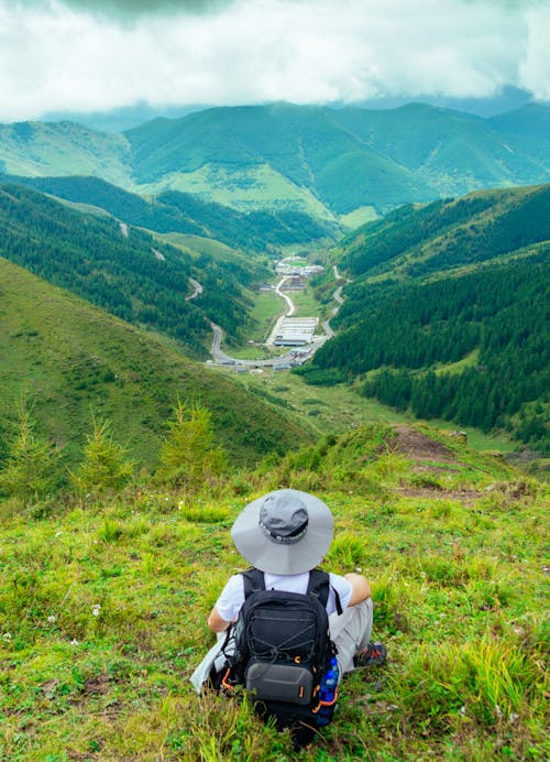 Backpacker Looking at Lush Green Mountain Landscape