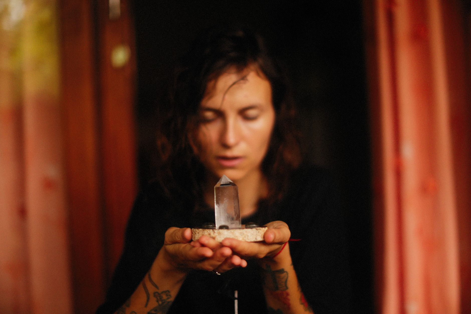 person meditating with grounding crystals for centering and stability