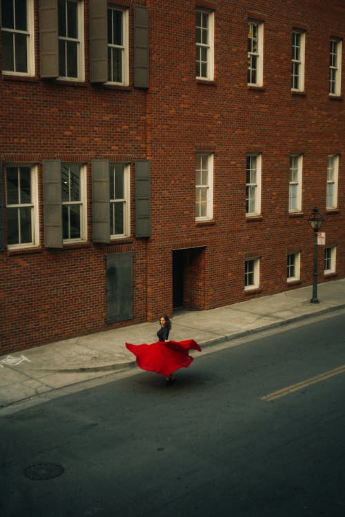 Free Woman in Red Skirt Dancing on the Street Stock Photo