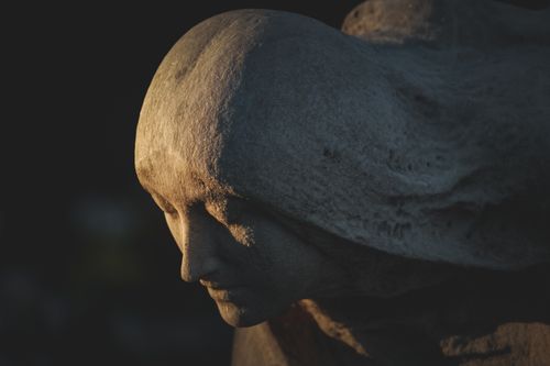 Free Close-up of a serene stone sculpture in soft light, showcasing intricate details. Stock Photo