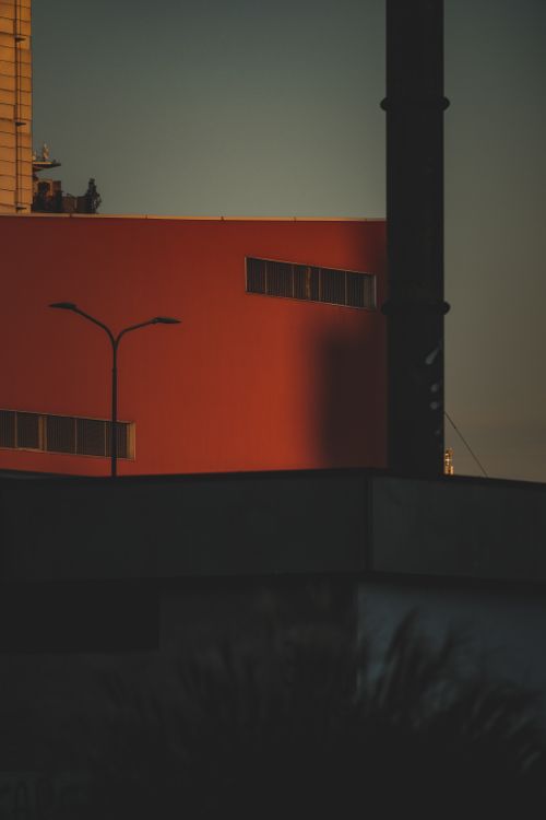 Free Urban architectural silhouette with sunset casting dramatic shadows, featuring modern buildings. Stock Photo