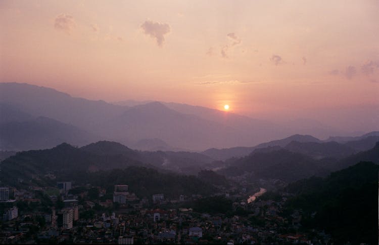 Aerial View Of A Town In A Mountain Valley At Sunset 