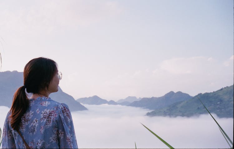 Young Woman Looking At View In Mountain Landscape