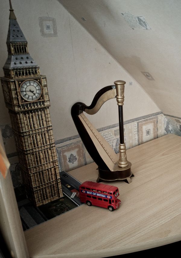 Miniature Big Ben model with a harp and red London bus toy