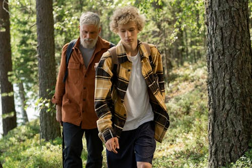 Free Elderly Man Walking in the Woods with a Boy Stock Photo