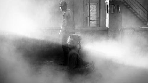 Free Man and Woman Inside a Building Full of Dust Stock Photo