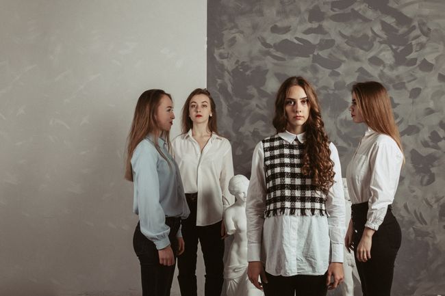 A group portrait shot against a coloured backdrop. Photo by Ilyasick Photo on Pexels