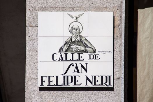 Tile street sign depicting Saint Philip Neri on Calle de San Felipe Neri in Madrid, Spain.