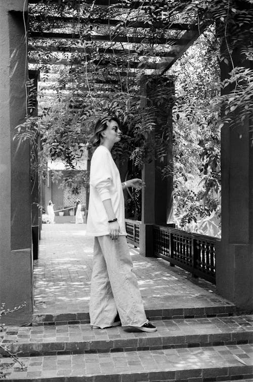 Grayscale Photo of a Woman in White Long Sleeve Shirt