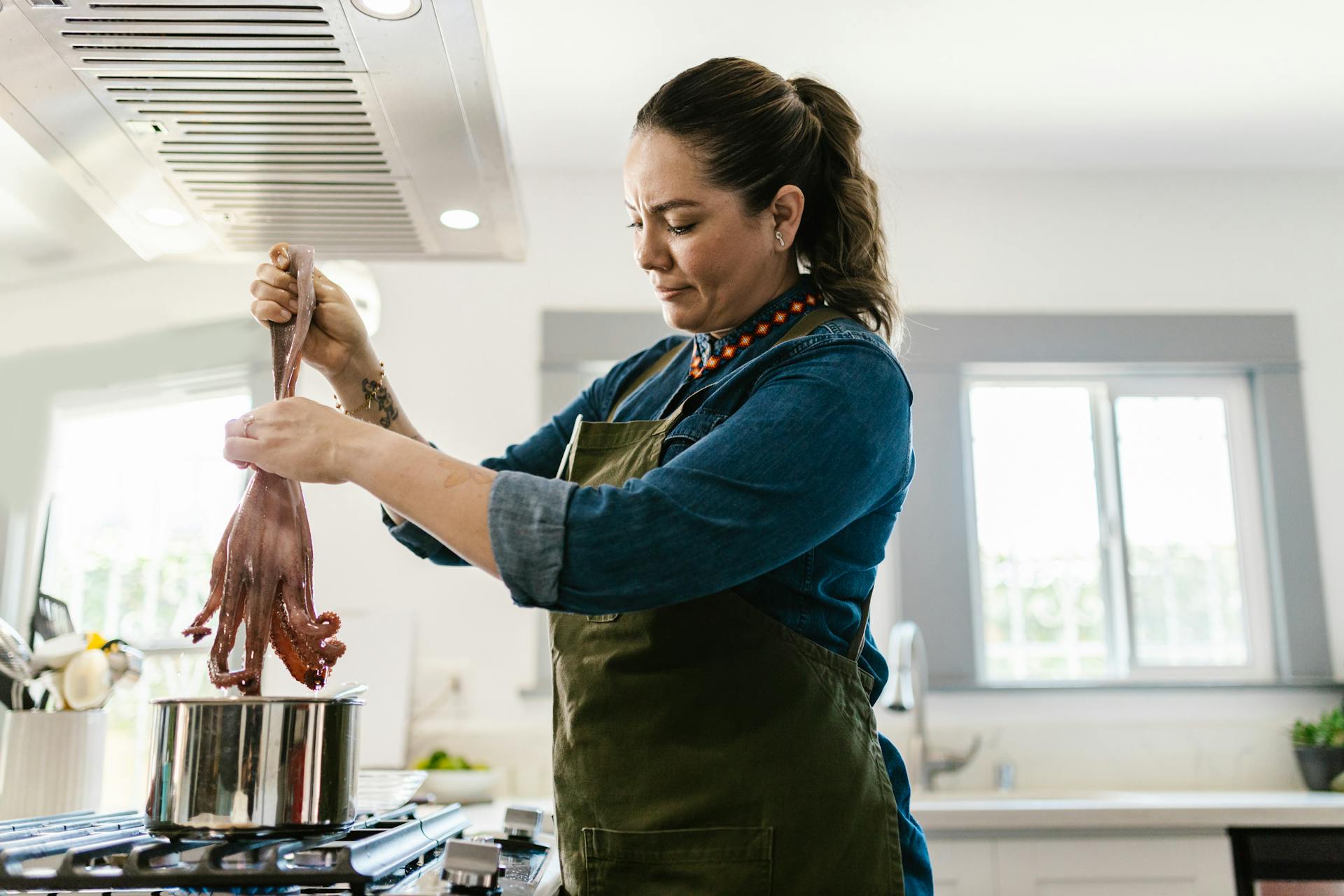 Woman Holding Octopus Above Pot