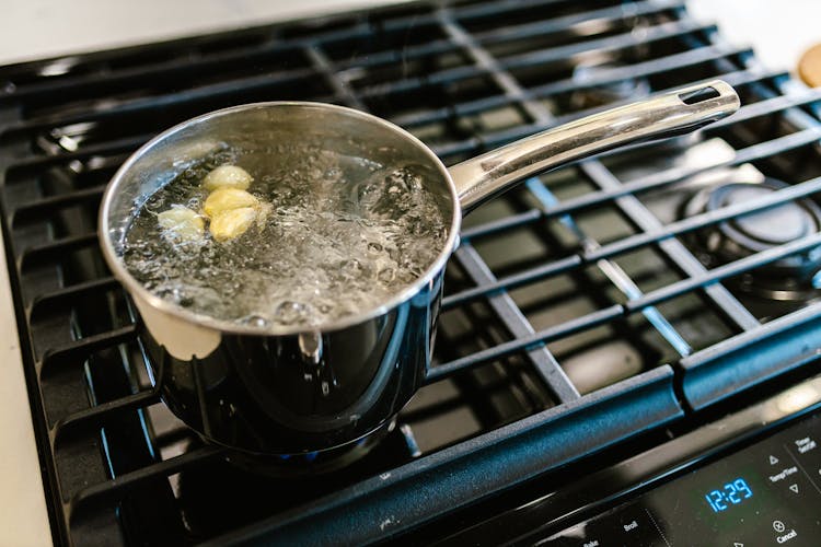 Pot With Boiling Water And Garlic