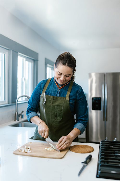 Woman Cutting Garlic with Knife · Free Stock Photo